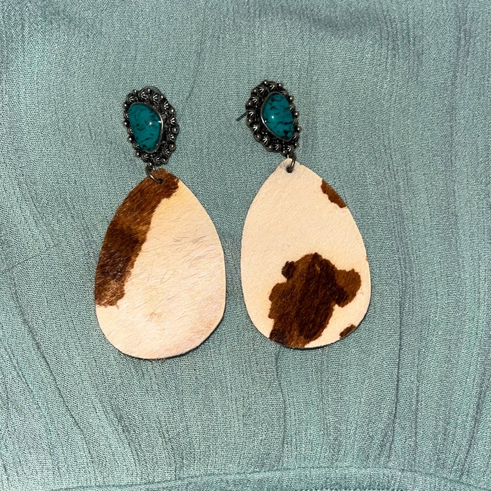 turquoise and cow print earrings.